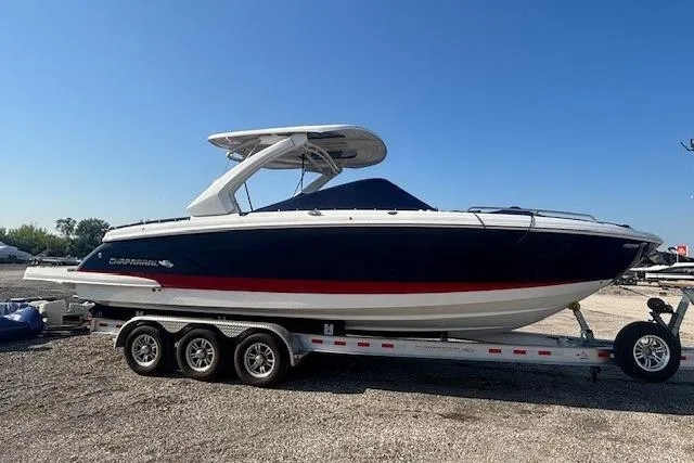 Slide: The Image of 2023 Chaparral 307 SSX boat on trailer under clear blue sky. - 24