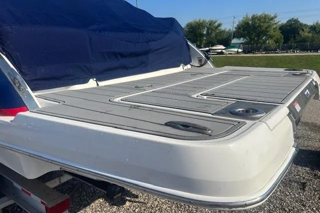 Slide: The Image of 2023 Chaparral 307 SSX boat with covered deck, parked outdoors. - 28