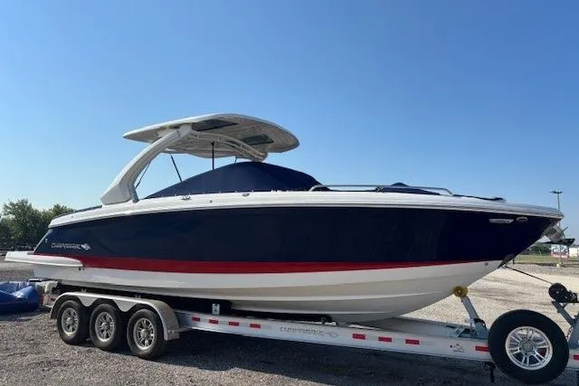 Slide: The Image of 2023 Chaparral 307 SSX boat on a trailer under clear blue sky. - 3