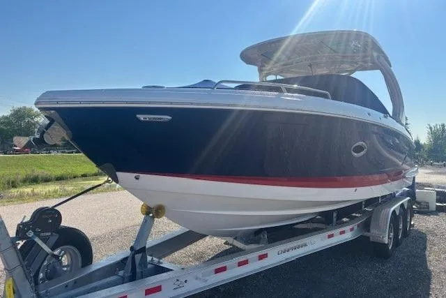 Slide: The Image of 2023 Chaparral 307 SSX boat on trailer under clear blue sky. - 30