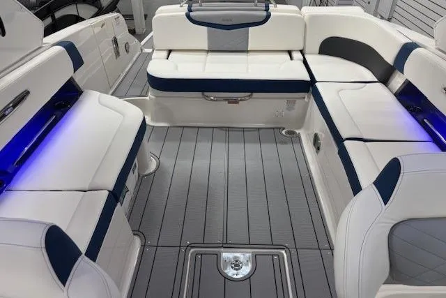 Slide: The Image of 2023 Chaparral 307 SSX boat interior with luxurious seating and ambient lighting. - 31