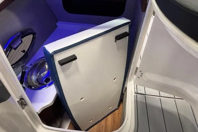 Slide: The Image of 2023 Chaparral 307 SSX boat interior with sink and storage compartment. - 41