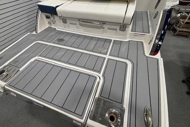 Slide: The Image of 2023 Chaparral 307 SSX boat deck with gray non-slip surface and seating area. - 43