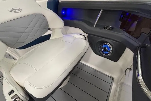 Slide: The Image of 2023 Chaparral 307 SSX interior with white leather seating and blue LED lighting. - 44