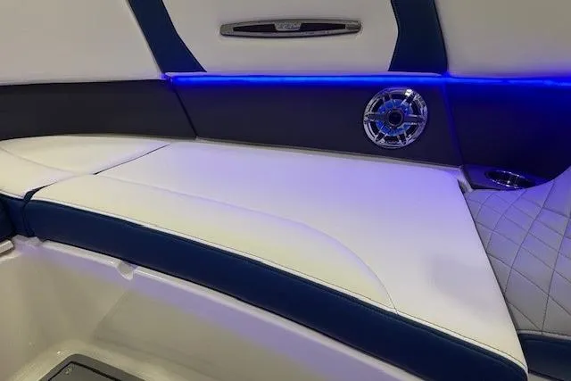 Slide: The Image of 2023 Chaparral 307 SSX boat interior with blue LED lighting and luxurious seating. - 45