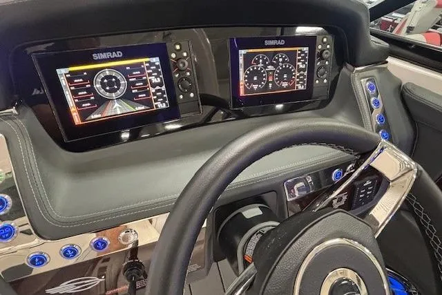 Slide: The Image of 2023 Chaparral 307 SSX dashboard with dual Simrad displays and modern controls. - 47
