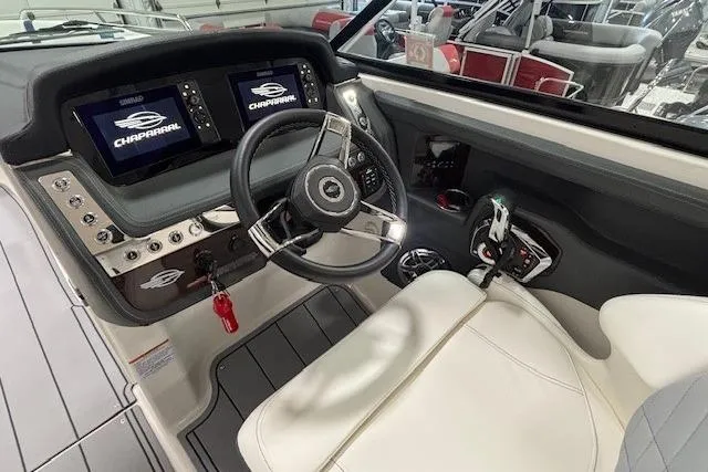 Slide: The Image of 2023 Chaparral 307 SSX boat cockpit with modern steering and dual displays. - 49