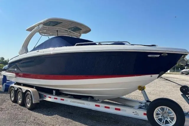 Slide: The Image of 2023 Chaparral 307 SSX boat on trailer, blue and white with red stripe. - 5