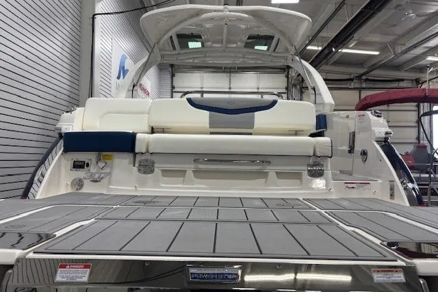 Slide: The Image of 2023 Chaparral 307 SSX boat in showroom, rear view with swim platform. - 52