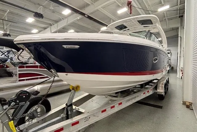 Slide: The Image of 2023 Chaparral 307 SSX boat on trailer in indoor showroom. - 57