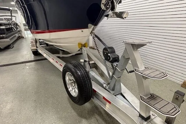 Slide: The Image of 2023 Chaparral 307 SSX boat on trailer in indoor storage facility. - 58