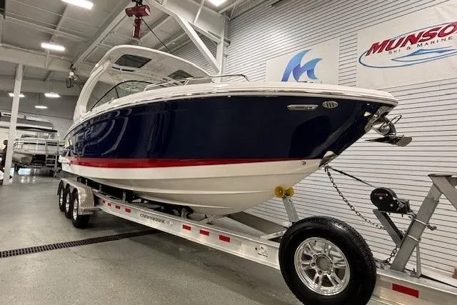 Slide: The Image of 2023 Chaparral 307 SSX boat on trailer in showroom, side view. - 60