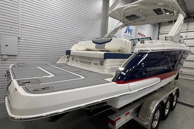 Slide: The Image of 2023 Chaparral 307 SSX boat on trailer in showroom, rear view. - 61