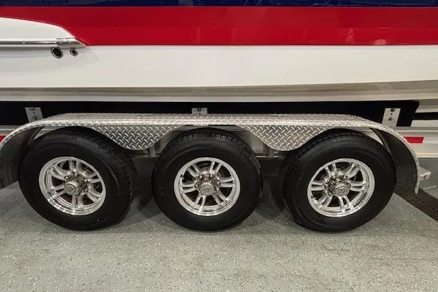 Slide: The Image of Triple-axle trailer for 2023 Chaparral 307 SSX boat, featuring diamond plate fenders. - 64