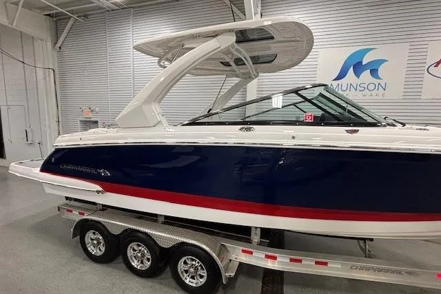 Slide: The Image of 2023 Chaparral 307 SSX boat on a trailer in a showroom setting. - 65