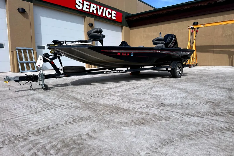 Slide: The Image of 2017 Ranger RT188 boat on trailer outside service center. - 1