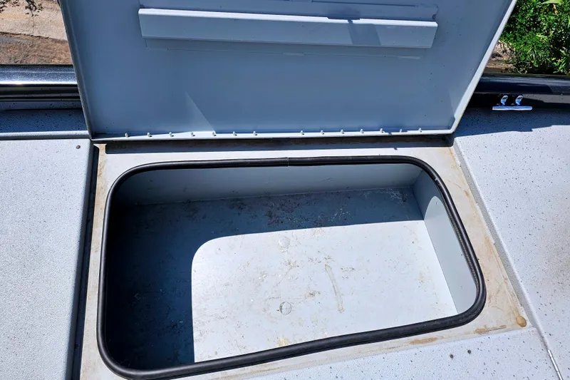 Slide: The Image of Open storage compartment on a 2017 Ranger RT188 boat, showing interior space. - 13