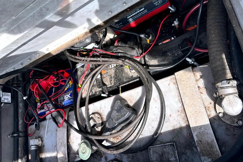 Slide: The Image of 2017 Ranger RT188 boat battery compartment with cables and wiring. - 17