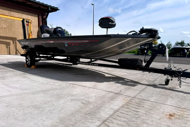 Slide: The Image of 2017 Ranger RT188 fishing boat on trailer, parked outdoors. - 2
