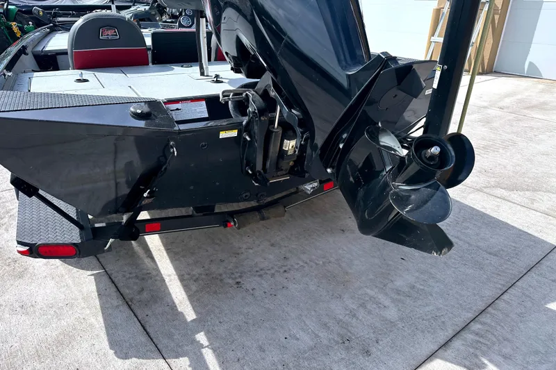 Slide: The Image of 2017 Ranger RT188 boat with a black motor and propeller on a concrete surface. - 5