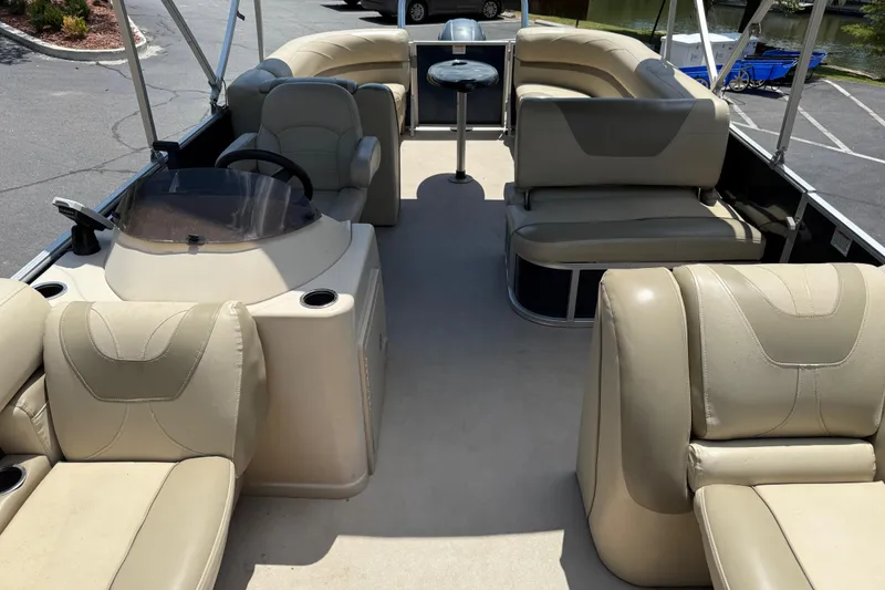 Slide: The Image of 2019 SunChaser Geneva Cruise 22 LR PSB pontoon boat with beige seating and steering console. - 13