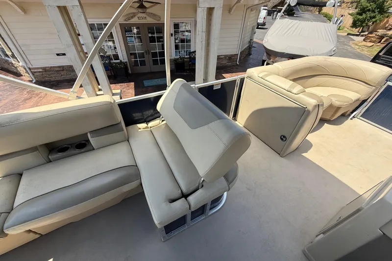 Slide: The Image of 2019 SunChaser Geneva Cruise 22 LR PSB pontoon boat with beige seating and cup holders. - 17