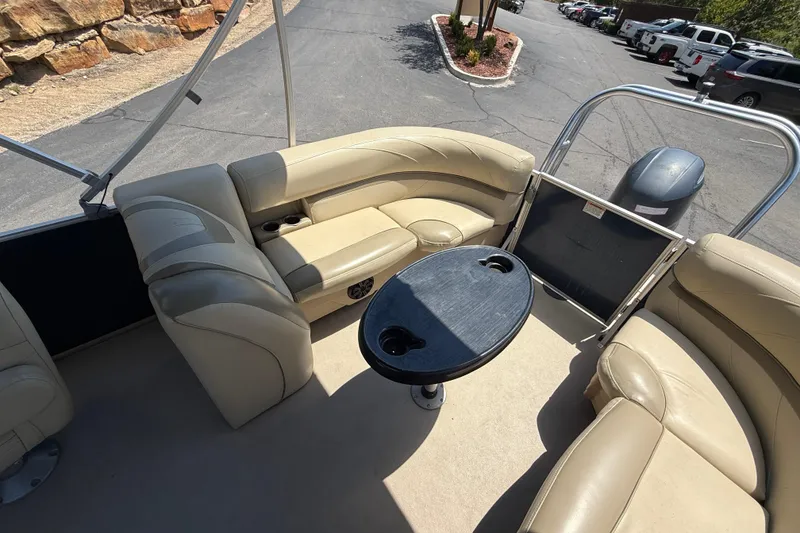 Slide: The Image of 2019 SunChaser Geneva Cruise 22 LR PSB pontoon boat interior with beige seating and table. - 20