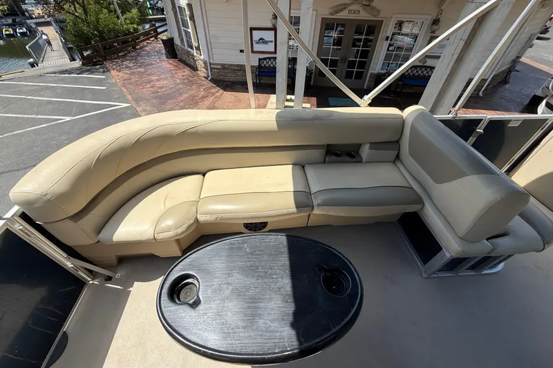 Slide: The Image of 2019 SunChaser Geneva Cruise 22 LR PSB pontoon boat with beige seating and black table. - 21