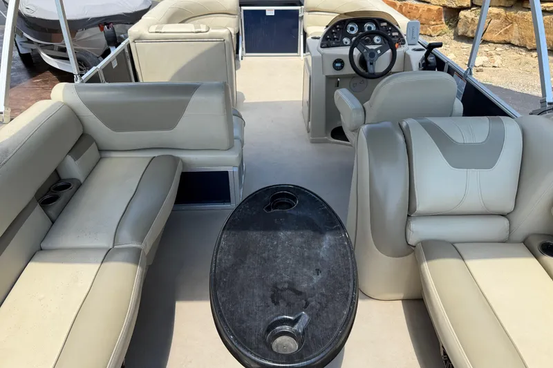 Slide: The Image of 2019 SunChaser Geneva Cruise 22 LR PSB interior with beige seating and steering console. - 23