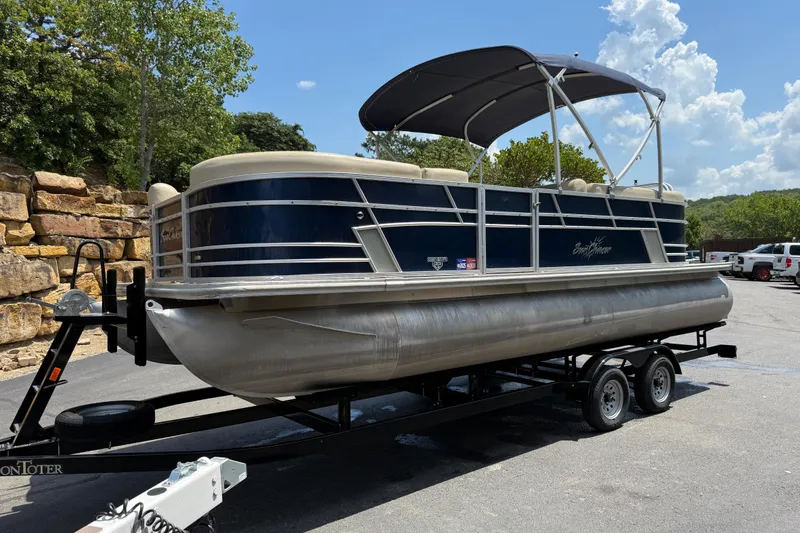 Slide: The Image of 2019 SunChaser Geneva Cruise 22 LR PSB pontoon boat on trailer, parked outdoors. - 4