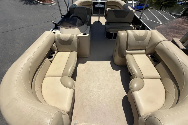 Slide: The Image of 2019 SunChaser Geneva Cruise 22 LR PSB pontoon boat with beige seating and spacious layout. - 7