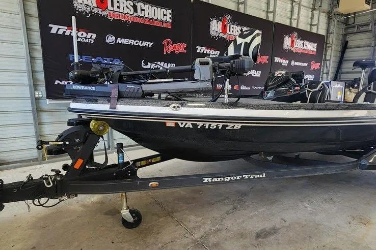 Slide: The Image of 2023 Ranger Z520R boat on trailer in garage, featuring Lowrance equipment and Anglers Choice branding. - 3