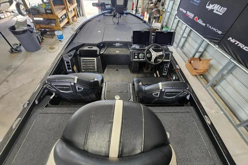 Slide: The Image of 2023 Ranger Z520R boat interior with dual seats and advanced dashboard in a garage setting. - 4