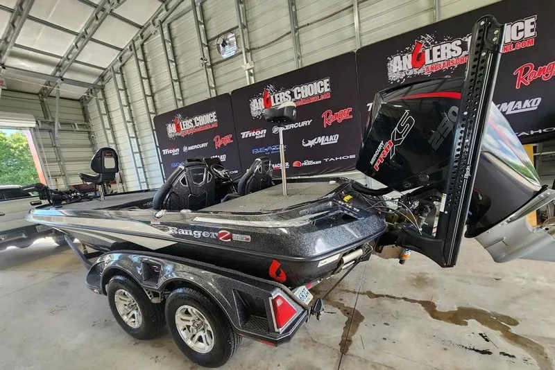 Slide: The Image of 2023 Ranger Z520R bass boat in a garage, featuring a powerful engine and sleek design. - 5
