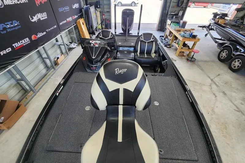 Slide: The Image of 2023 Ranger Z520R boat interior in a garage, featuring sleek seating and storage compartments. - 6