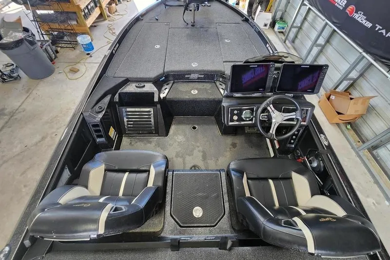 Slide: The Image of 2023 Ranger Z520R boat interior with dual screens and leather seats in a garage setting. - 7