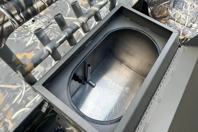 Slide: The Image of War Eagle 2170 Blackhawk 2026 boat interior with storage compartment and camouflage seating. - 13