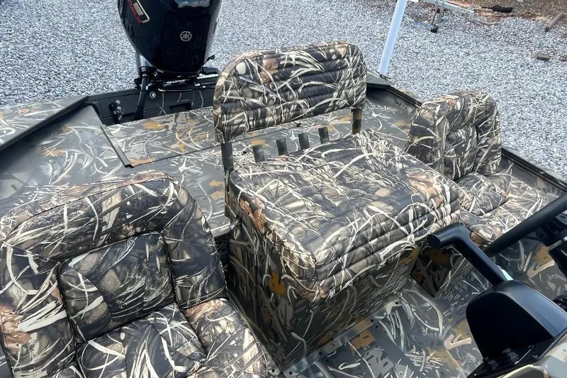 Slide: The Image of 2026 War Eagle 2170 Blackhawk boat interior with camouflage seating and motor. - 14