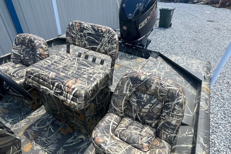 Slide: The Image of 2026 War Eagle 2170 Blackhawk boat with camo seats and powerful outboard motor. - 6