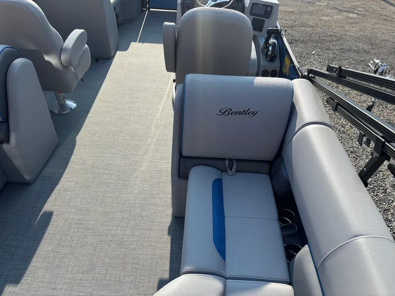 Slide: The Image of 2025 Bentley Pontoons Legacy Navigator interior with gray seating and steering console. - 2