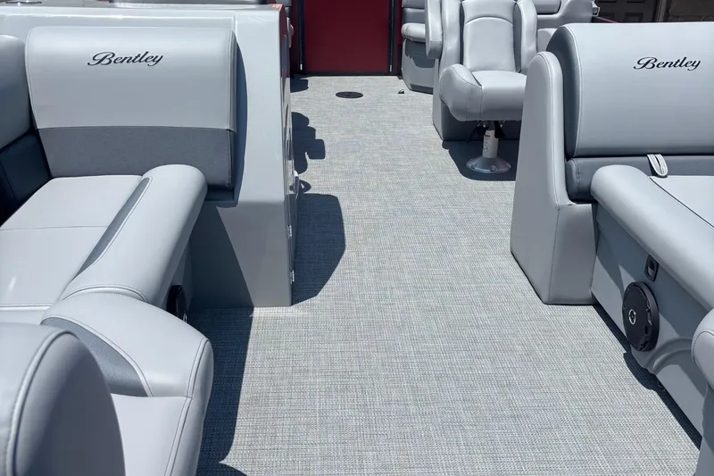 Slide: The Image of 2025 Bentley Pontoons Legacy Navigator interior with luxurious gray seating and carpet. - 7