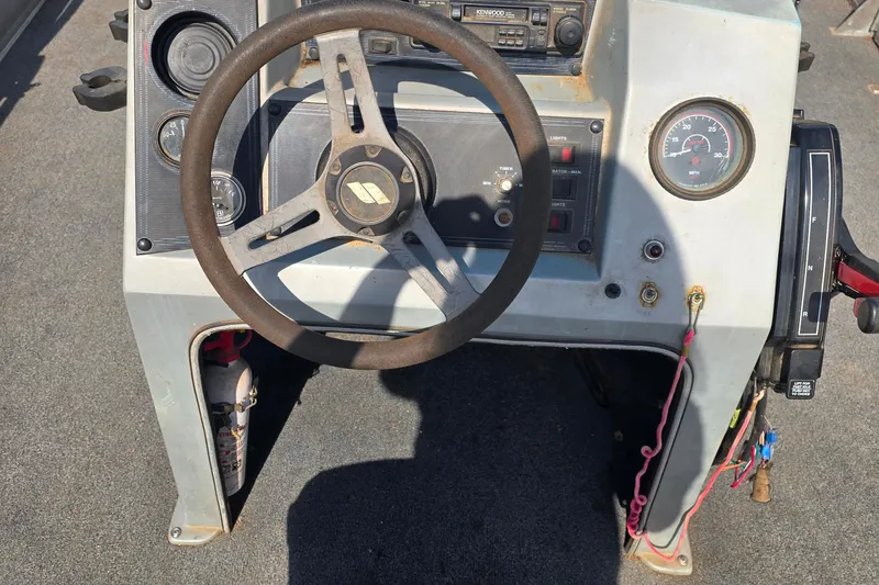 Slide: The Image of 1988 Starcraft SD200 boat dashboard with steering wheel and control panel. - 6