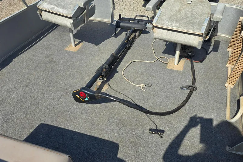 Slide: The Image of 1988 Starcraft SD200 boat interior with fishing equipment and seating. - 7