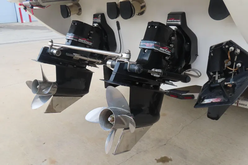 Slide: The Image of Twin propellers on a 1998 Magic 34 Sorcerer boat, featuring MerCruiser drives. - 20