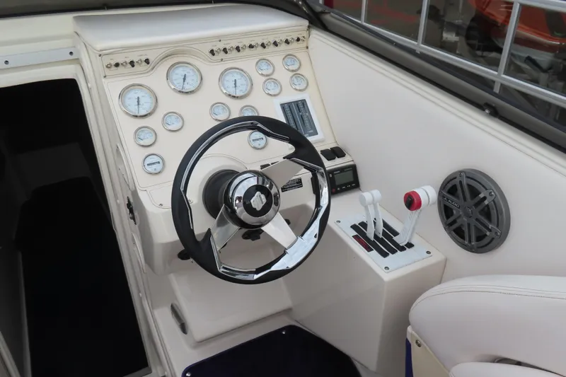 Slide: The Image of Cockpit of 1998 Magic 34 Sorcerer boat with steering wheel and control panel. - 9
