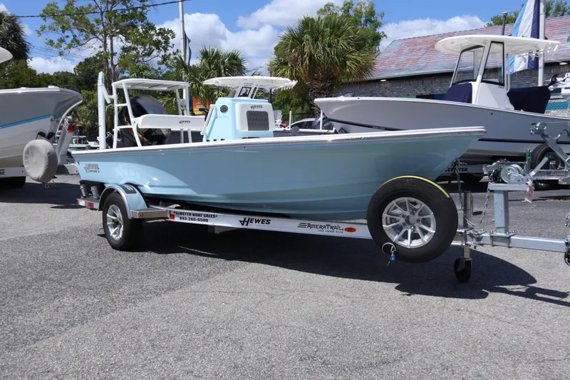 Slide: The Image of 2025 Hewes Redfisher 16 boat on trailer, displayed outdoors with other boats. - 1