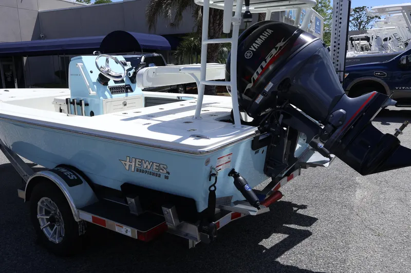 Slide: The Image of 2025 Hewes Redfisher 16 boat with Yamaha outboard motor on trailer. - 2