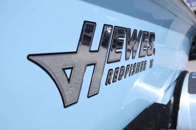 Slide: The Image of 2025 Hewes Redfisher 16 boat logo on light blue hull. - 3