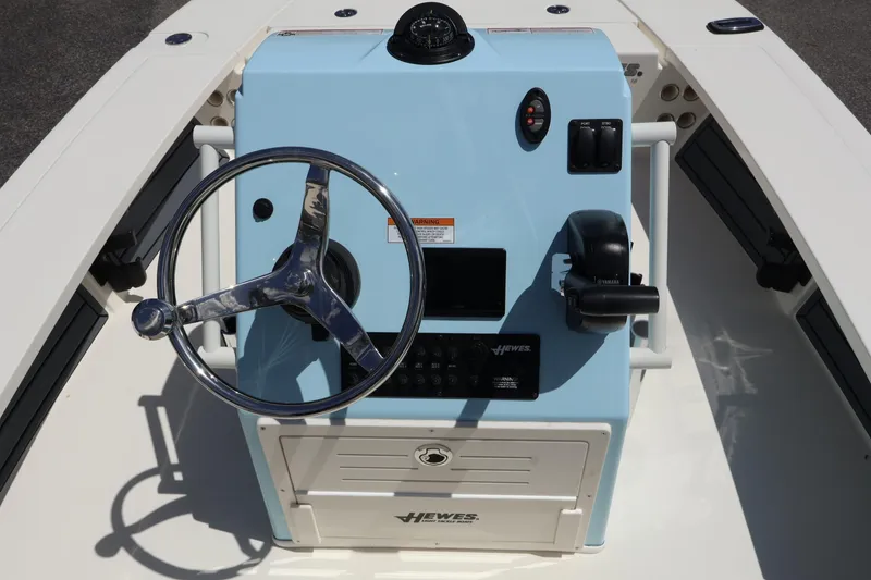 Slide: The Image of 2025 Hewes Redfisher 16 boat console with steering wheel and controls. - 6