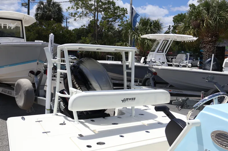 Slide: The Image of 2025 Hewes Redfisher 16 boat with Yamaha engine, displayed outdoors among other boats. - 9